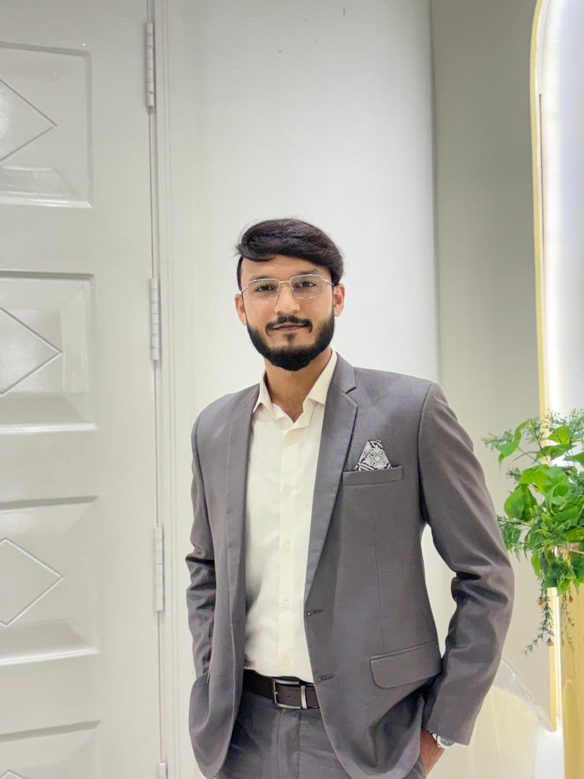Muhammad Mohnis Mustafa, founder of M-Cube Institute, wearing a grey suit